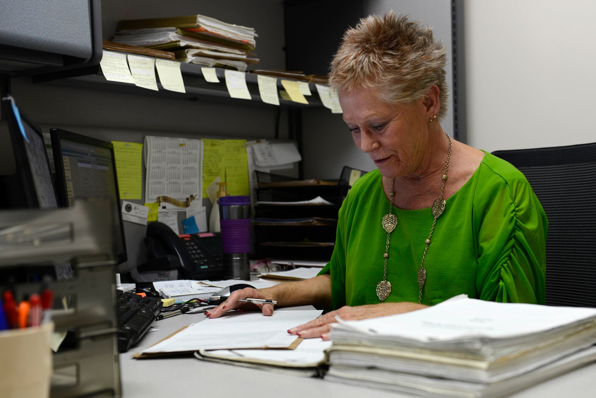 Sandy Geer, 22nd Aerospace Medicine Squadron records auditor, reviews a service member’s medical record, Oct. 21, 2015, at McConnell Air Force Base, Kansas. The separation history physical exam process began in January and has since cut down the time it takes for members filing claims with the Department of Veterans Affairs by more than half. (U.S. Air Force photo/Senior Airman Trevor Rhynes)