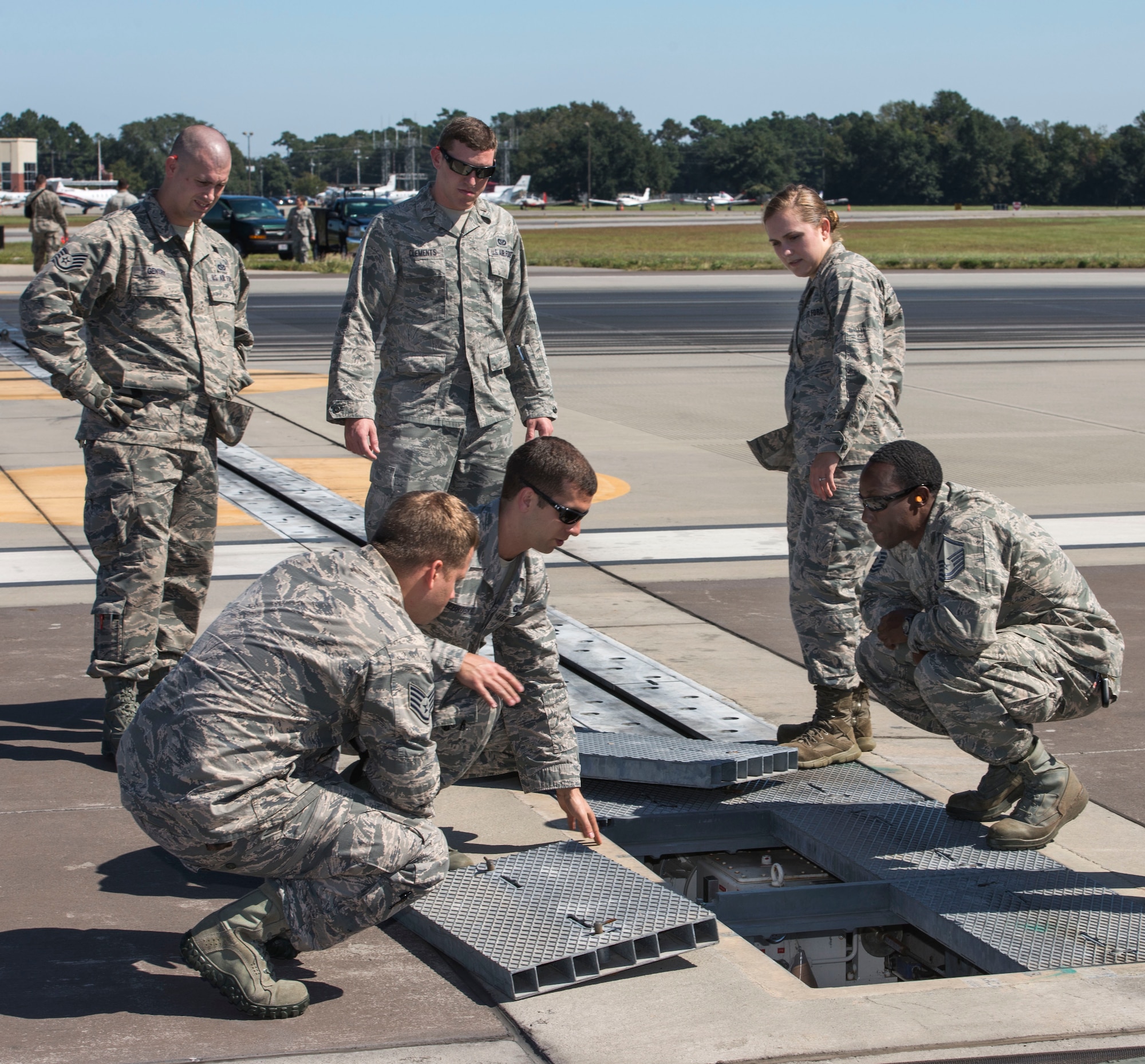 Members from the 628th Civil Engineering Squadron reset the aircraft arresting system on the flight line after being tested by an F-16 Fighting Falcon from Shaw Air Force Base, S.C., at Joint Base Charleston – AB, S.C., on Oct. 14, 2015. The AAS is used on U.S. Navy aircraft carriers. JB Charleston is one of a few land bases that have the AAS installed. (U.S. Air Force photo/Airman 1st Class Thomas T. Charlton)