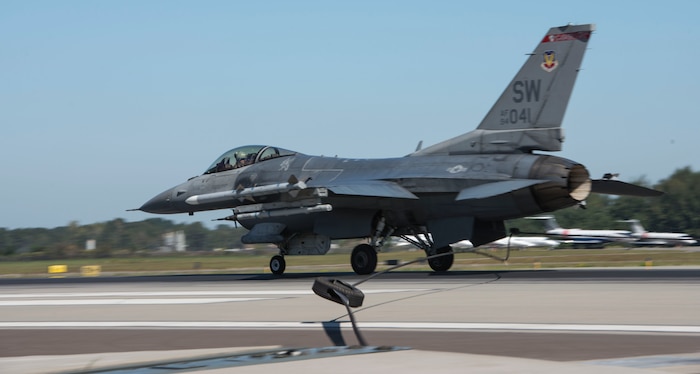 An F-16 Fighting Falcon from Shaw Air Force Base, S.C., flew in to help the 628th Civil Engineering Squadron test the aircraft arresting system on the flight line at Joint Base Charleston – AB, S.C., on Oct. 14, 2015.  The F-16 Fighting Falcon had to travel at least 70 knots to trip the AAS successfully. (U.S. Air Force photo/Airman 1st Class Thomas T. Charlton)