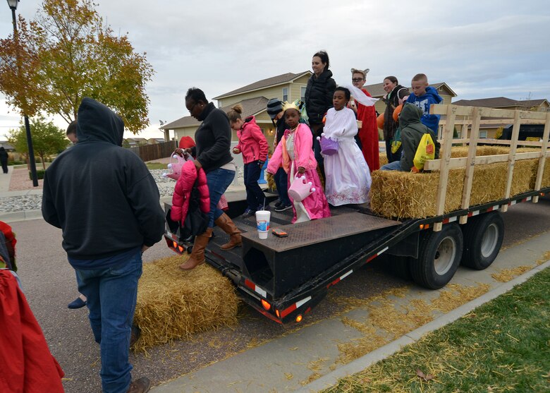 Schriever Air Force Base families disembark a hayride during the Fall Harvest Festival at the Tierra Vista Communities Community Center at Schriever Air Force Base, Colorado, Friday, Oct. 23, 2015. The festival was followed by a trunk-or-treat hosted by Girl Scout Troop 543. (U.S. Air Force photo/Staff Sgt. Debbie Lockhart)
