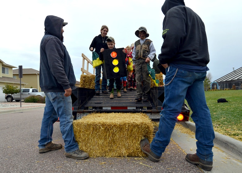 Schriever Air Force Base families disembark a hayride during the Fall Harvest Festival at the Tierra Vista Communities Community Center at Schriever Air Force Base, Colorado, Friday, Oct. 23, 2015. The 50th Force Support Squadron hosted the event which included inflatable bounce houses, games, a pumpkin patch, hay ride and free food. (U.S. Air Force photo/Staff Sgt. Debbie Lockhart)