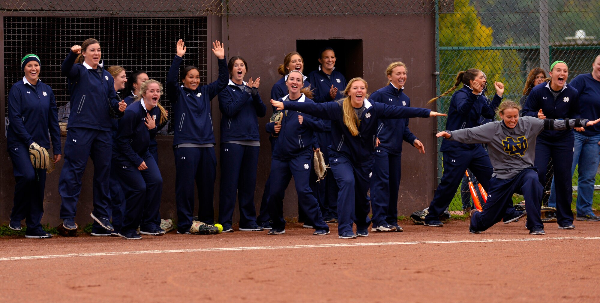 Members of the University of Notre Dame softball team celebrate during a scrimmage against the Ramstein Air Base Lady Rams Oct. 21, 2015, at Ramstein Air Base, Germany. The scrimmage was part of the Notre Dame softball team’s base visit during their 10-day European tour. Notre Dame team members also held softball instructional clinics for students at Ramstein and Kaiserslautern High Schools. (U.S. Air Force photo/Staff Sgt. Sharida Jackson