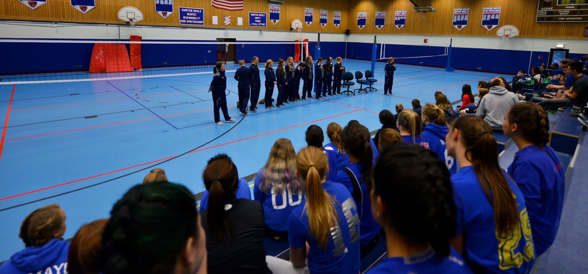 Students from Ramstein High School listen to members of the University of Notre Dame softball team during their visit to the school Oct. 21, 2015, at Ramstein Air Base, Germany. Notre Dame players held softball clinics with varsity softball players from both Ramstein and Kaiserslautern High Schools. (U.S. Air Force photo/Staff Sgt. Sharida Jackson)