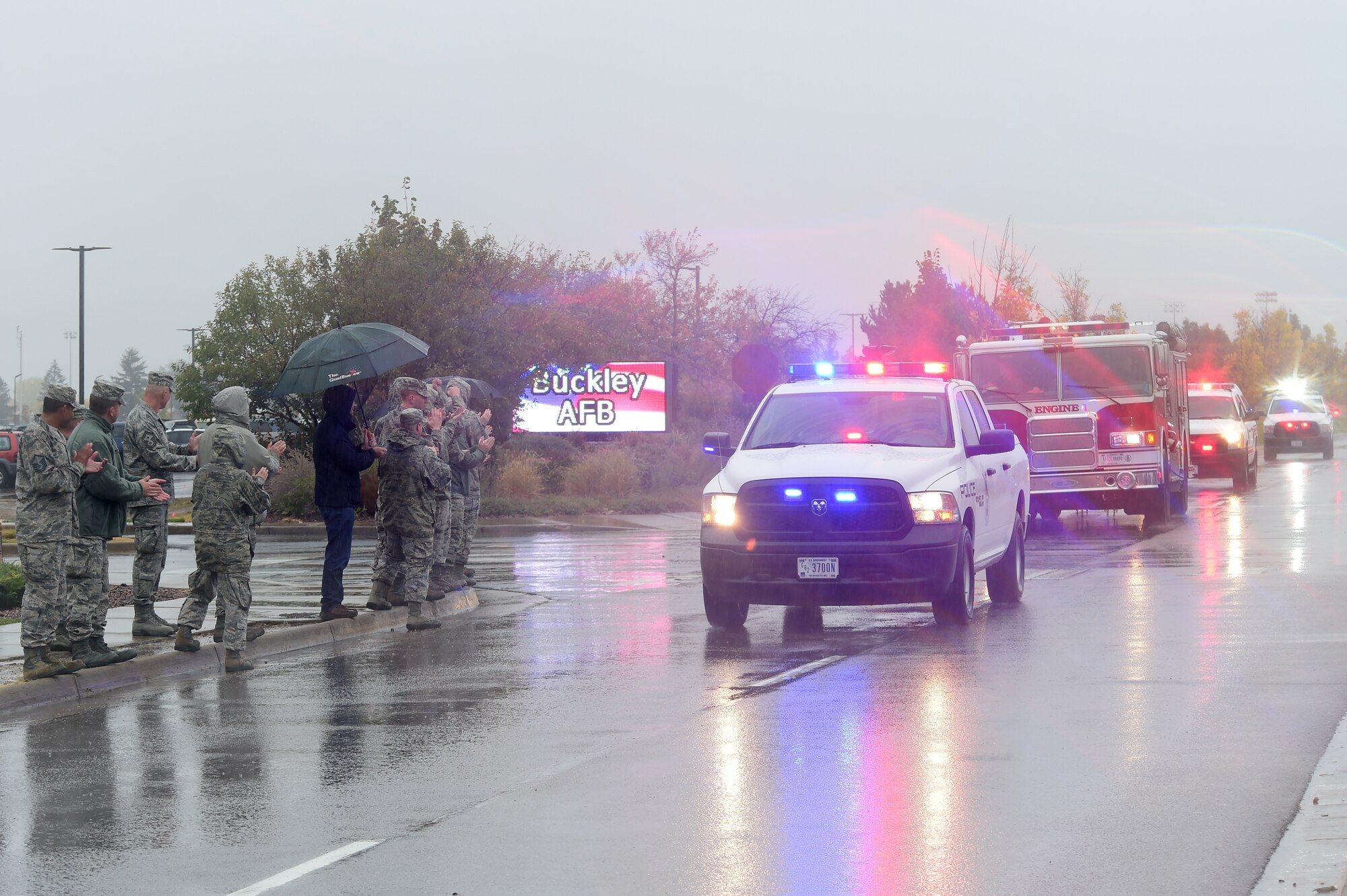 Team Buckley members line the streets to welcome home Master Sgt. Troy Drasher, 2nd Space Warning Squadron first sergeant, Oct. 22, 2015, on Buckley Air Force Base, Colo. Drasher received national attention after completing a 720 mile run from Aurora, Colo. to Abilene, Texas, in order to raise money and awareness for wounded warriors. (U.S. Air Force photo by Airman 1st Class Luke W. Nowakowski/Released)