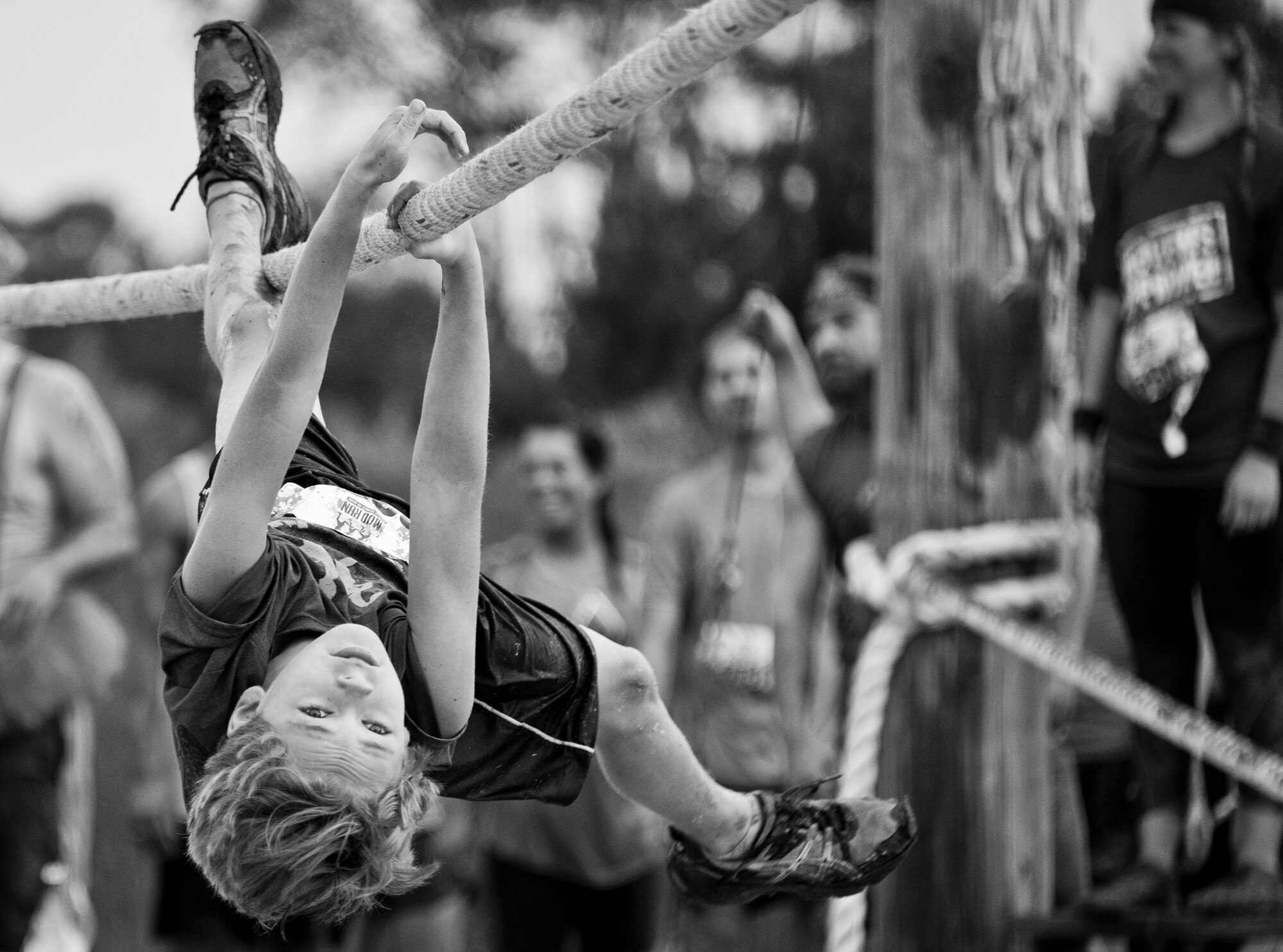 A competitor reaches forward as he moves along the rope -line obstacle during the Pensacola Mud Run Oct 24. Active duty and reserve service members from many local military bases came out to get dirty in the five-mile, 20-obstacle challenge.  (U.S. Air Force photo/Tech. Sgt. Sam King)