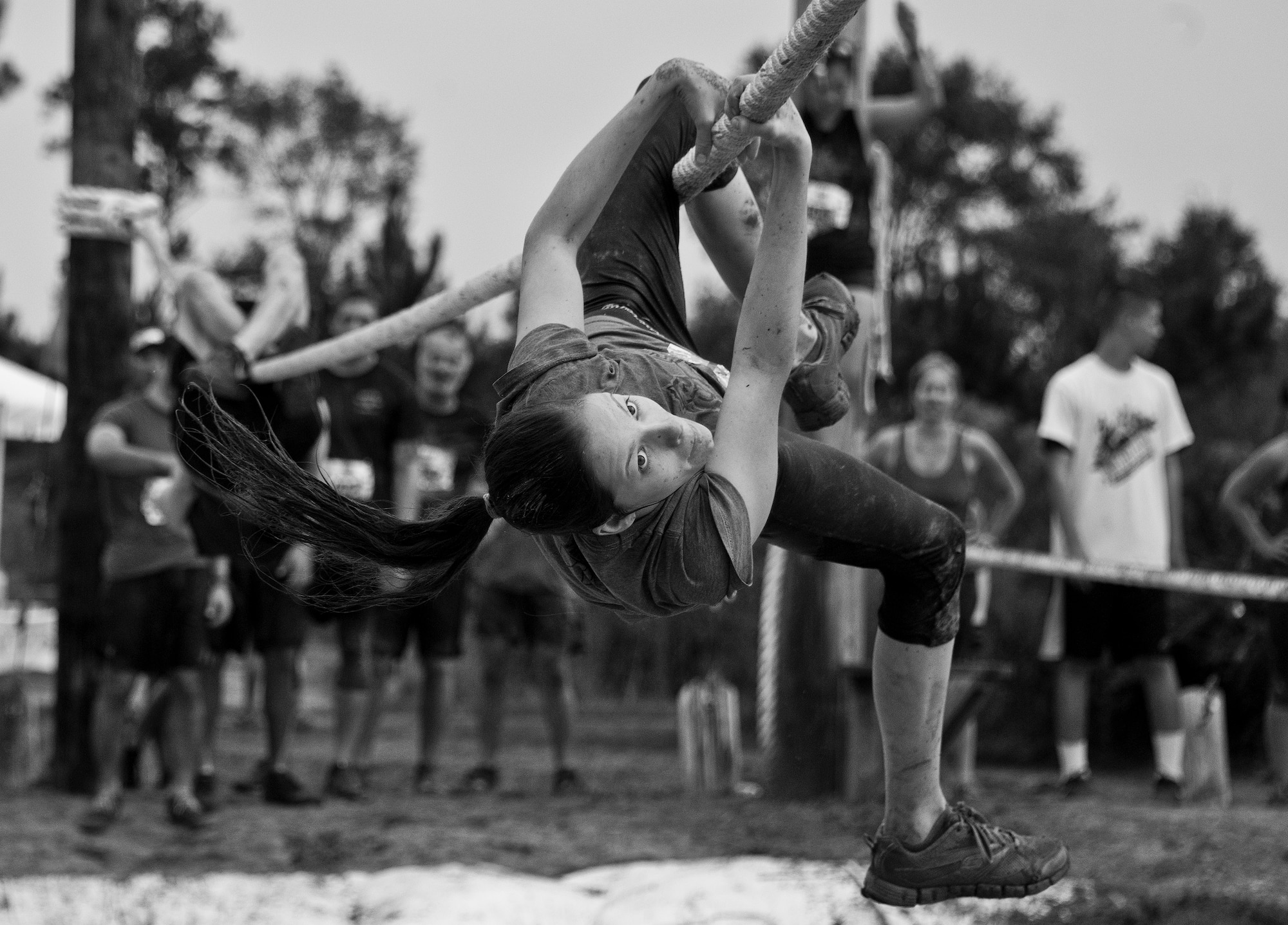 A competitor keeps her eyes toward her goal as she moves along the rope -line obstacle during the Pensacola Mud Run Oct 24. Active duty and reserve service members from many local military bases came out to get dirty in the five-mile, 20-obstacle challenge.  (U.S. Air Force photo/Tech. Sgt. Sam King)