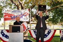 Dr. Dave Hansen, 309th Electronics Maintenance Group director, holds aloft the commemorative plaque, presented by Brad Baptiste, left, designating the unit as a Voluntary Protection Program Star status site. Baptiste is the regional VPP manger from the Denver Department of Labor office, and led the evaluation team that recommended the unit be designated as a Star worksite. (U.S. Air Force photo by R. Nial Bradshaw)
