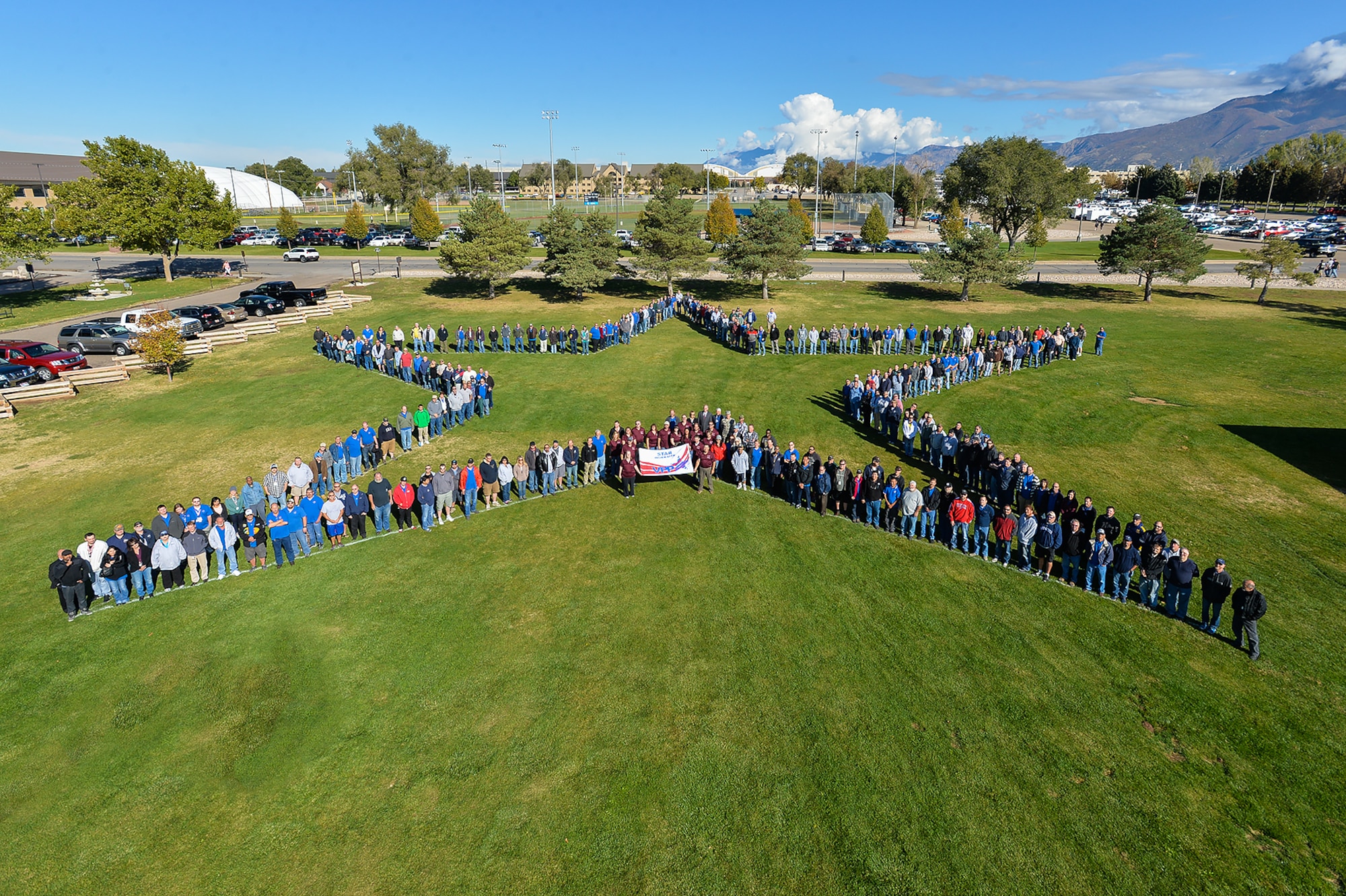 Employees from the 309th Electronics Maintenance Group form a star in Hill Air Force Base's Centennial Park in recognition of their achieving Star status in the Voluntary Protection Program. The group was honored Oct. 20 by representatives from the U.S. Department of Labor, the Undersecretary of Defense and the American Federation of Government Employees Local 1592. (U.S. Air Force photo by R. Nial Bradshaw)
