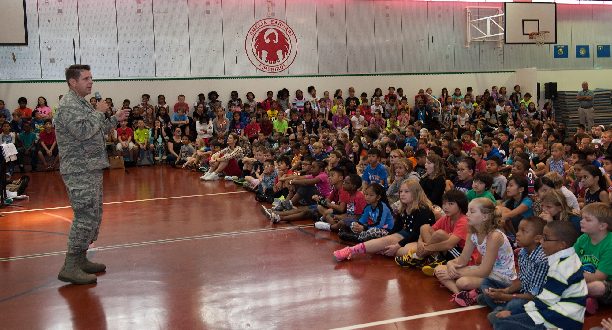 U.S. Air Force Col. Christopher Amrhein, 18th Wing vice commander, speaks to students at Amelia Earhart Intermediate School about Red Ribbon Week Oct. 26, 2015, on Kadena Air Base, Japan. Amrhein was a guest speaker for the students and emphasized the importance of drug prevention. Red Ribbon Week is held to educate youth about the importance of being drug-free and will continue until Oct. 30. (U.S. Air Force photo by Airman 1st Class Lynette M. Rolen)