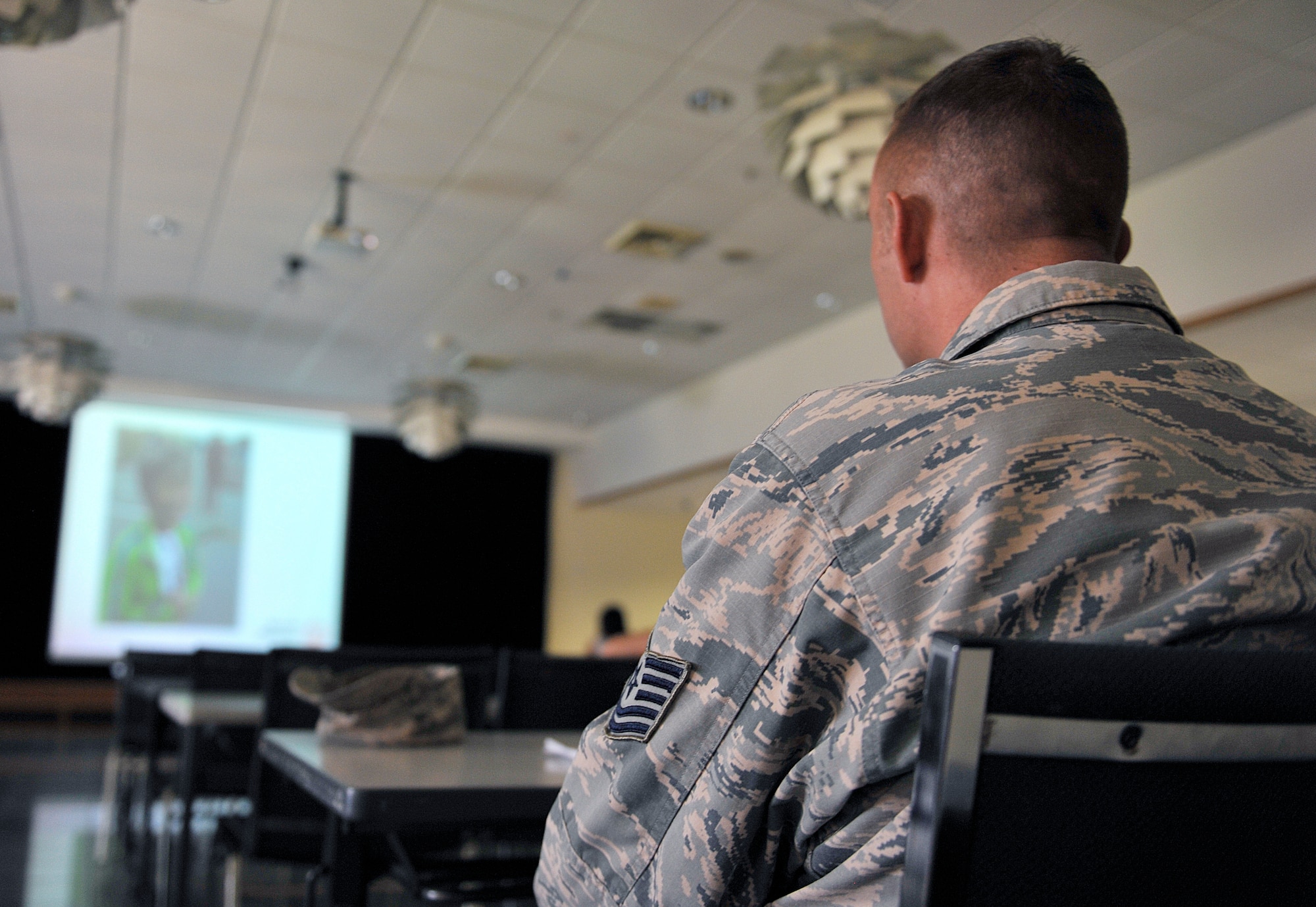 U.S. Air Force Tech. Sgt. Jeffrey Green, 18th Logistics Readiness Squadron non-commissioned officer in charge of the base fuels laboratory, listens to a briefing for Kadena Special Olympics, Oct. 26, 2015, at the Schilling Community Center on Kadena Air Base, Japan. More than 450 interpreters registered to assist athletes for the upcoming 16th annual KSO. (U.S. Air Force photo by Naoto Anazawa)