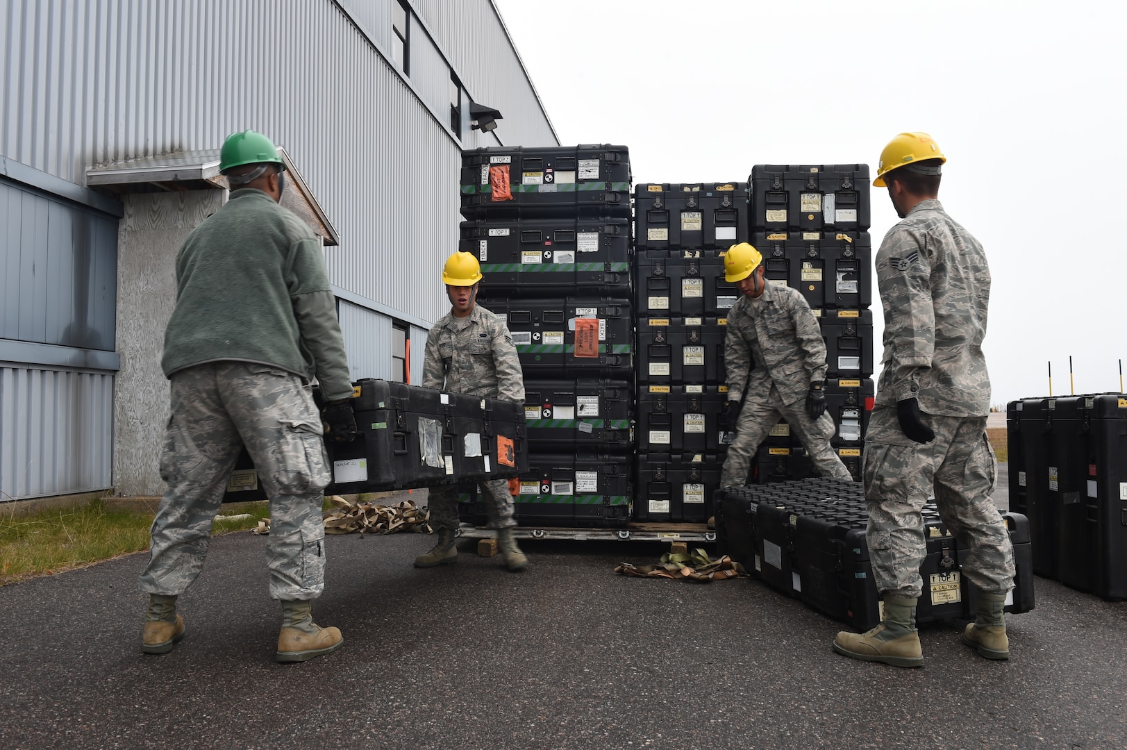 Airmen assigned to the 52nd Combat Communications Squadron move cases of communication equipment during Vigilant Shield 16 at 5 Wing Goose Bay, Canada, Oct. 10, 2015. From October 15-26, 2015 approximately 700 members from the Canadian Armed Forces, the United States Air Force, the United States Navy, and the United States Air National Guard are deploying to Iqualuit, Nunavut, and 5 Wing Goose Bay, Newfoundland and Labrador for Exercise Vigilant Shield 16. (U.S. Air Force photo by Senior Airman Jasmonet Jackson/ Released)