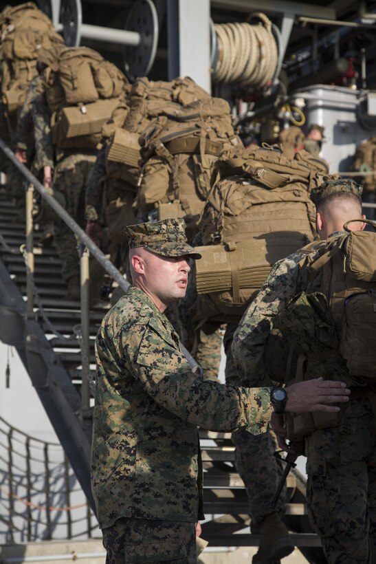 U.S. Marine Corps 1st Sgt. Matthew Holcomb , company first sergeant for Alpha Company, 1st Battalion, 2nd Marine Regiment, currently assigned to 4th Marine Regiment, 3rd Marine Division, III Marine Expeditionary Force, on Unit Deployment Program, counts Marines embark USS Germantown during Exercise Blue Chromite 16 on White Beach, Okinawa, Japan, Oct. 27, 2015. Blue Chromite 16 exemplifies high-level, cost-effective training in a realistic, expeditionary environment. (U.S. Marine Corps photo by LCpl. Makenzie Fallon/Released) 