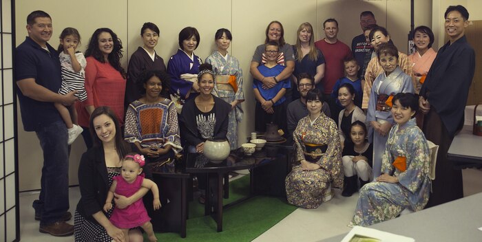 Station residents and instructors pose for a group photo during a tea ceremony with the Omotesenke Tea Ceremony Club hosted by the Cultural Adaptation Program at Marine Corps Air Station Iwakuni, Japan, Oct. 17, 2015. Programs like these help familiarize Americans with the culture of Japan, which they are now a part of.