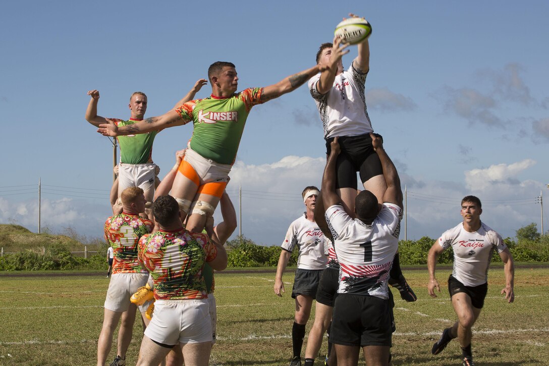 Members of the Camp Kinser Dragons and the Camp Hansen Kaiju Rugby Club compete for possession in a line-out during a friendly rugby match Oct. 24 aboard Camp Kinser, Okinawa, Japan. A line-out is a way of restarting play once the ball has passed the touch line. The Camp Hansen Kaiju Rugby Club is a Marine Corps Community Services sponsored team that participates in both friendly matches and league games with the Okinawa Rugby Football Union.