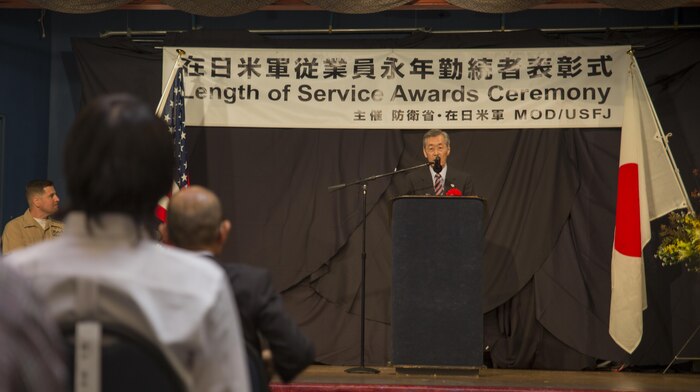 Yoshihiko Fukuda, Mayor of Iwakuni City, addresses attendees during the Length of Service Award Ceremony at the Club Iwakuni ballroom at Marine Corps Air Station Iwakuni, Japan, Oct. 22, 2015. The Length of Service Award Ceremony recognizes the Japanese civilian’s dedication and passion while working on the installation. Station and city officials expressed their appreciation towards the attendees for their efforts and contribution to the air station.