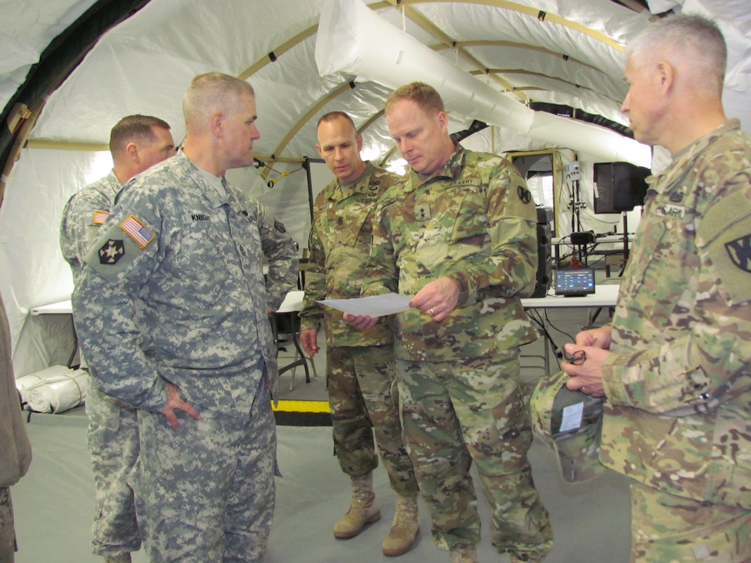 aj. Gen. Duane Gamble, commanding general of the 21st Theater Support Command, examines schematics of the 7th Mission Support Command's Tactical Command Post Monday Oct. 26, 2015 at Panzer Kaserne in Kaiserslautern, Germany. The 6,000 square foot star-shaped Tactical Command Post is a modular, portable and expandable system that can quickly be built to provide a brigade-sized operations center and shelter for up to 200 people. (Photo by Lt. Col. Jefferson Wolfe, 7th Mission Support Command Public Affairs Officer)