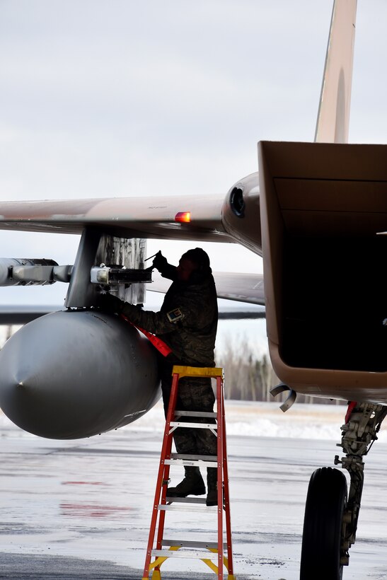 U.S. Air Force Staff Sgt. Michael Ekstrom pulls a pin on a F-15C Eagle before first mission launch during Exercise Vigilant Shield 16 from 5 Wing Goose Bay, Newfoundland, Oct. 19, 2015. Ekstrom is a crew chief for the 144th Maintenance Group. U.S. Air National Guard photo by Senior Master Sgt. Chris Drudge