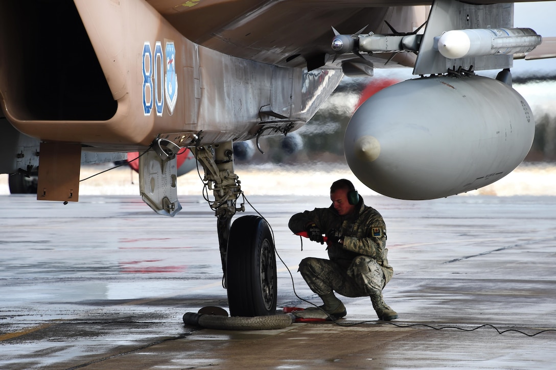U.S. Air Force Staff Sgt. Michael Ekstrom pulls a pin on an F-15C Eagle before first mission launch during Exercise Vigilant Shield 16 from 5 Wing Goose Bay, Newfoundland, Oct. 19, 2015. Ekstrom is a crew chief for the 144th Maintenance Group. U.S. Air National Guard photo by Senior Master Sgt. Chris Drudge