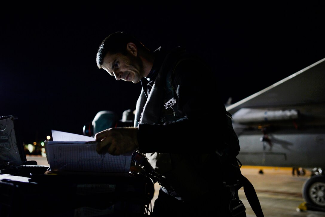 U.S. Air National Guard 1st. Lt. Johnathan Pavan goes through his safety checklist, preparing for a launch during Exercise Vigilant Shield 16 from 5 Wing Goose Bay, Newfoundland, Oct. 19, 2015. Pavan is a pilot assigned to the 194th Fighter Squadron. U.S. Air National Guard photo by Staff Sgt. Christian Jadot