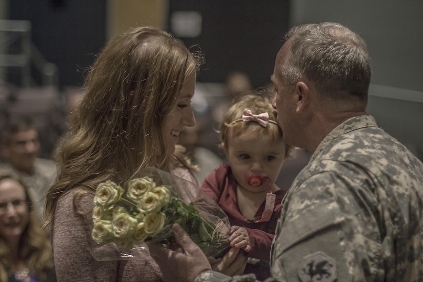 Brig. Gen. Richard Sele, 108th Training Command (IET) deputy commanding general, gives his grandaughter a kiss while presenting a bouquet of yellow roses to his daughter for her contributions, and patience, to the Army as a family member. Sele was promoted to the rank of Brig. Gen. during a ceremony hosted by Maj. Gen. Daniel Ammerman, United States Army Civil Affairs and Pychological Operations Command commanding general, at the Airborne and Special Operations Museum in Fayetteville, N.C., Oct. 25, 2015. Sele, a longtime civil affairs Soldier, takes over for Brig. Gen. A. Ray Royalty as the deputy commanding general of the 108th, headquartered in Charlotte, N.C. (U.S. Army photo by Sgt. 1st Class Brian Hamilton)