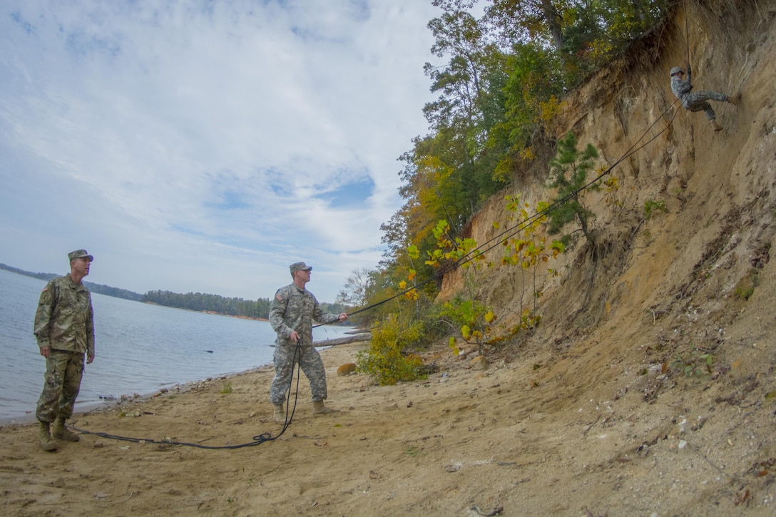 Army Reserve Capt. Michael Rode, of Boiling Springs, S.C., commander of Company D, 1st Bn. 518th Inf. Reg., 2nd Bde., 98th Training Div. (IET), and 1st Lt. Jeoffrey Fowler, of Company C, hold belay and instruct a Clemson University Reserve Officer Training Corps cadet as he rappels down a cliff on the shore of Lake Hartwell, Oct. 24, 2015. The Reserve officers were there as part of a contingent of 20 soldiers from the 108th Training Command (IET) who traveled to Clemson to aid the ROTC in its fall leadership training exercise. (U.S. Army photo by Sgt. Ken Scar)