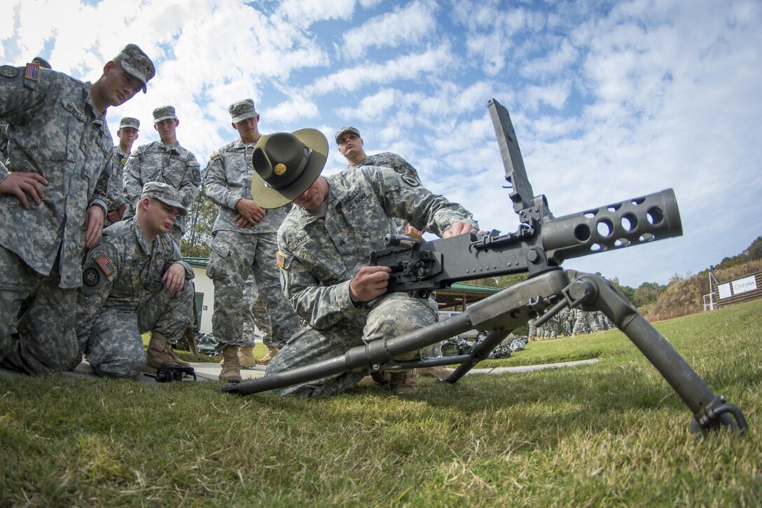 Army Reserve drill sergeant, Sgt. Larry Davis, of Greer, S.C., of 1st Bn., 518th Inf. Reg., 2nd Bde., 98th Training Div. (IET), teaches a group of Clemson University Reserve Officer Training Corps cadets how to pull apart a Browning M2 .50-caliber machine gun as part of a leadership training exercise in the Clemson Forest, Oct. 24, 2015. (U.S. Army photo by Sgt. Ken Scar)