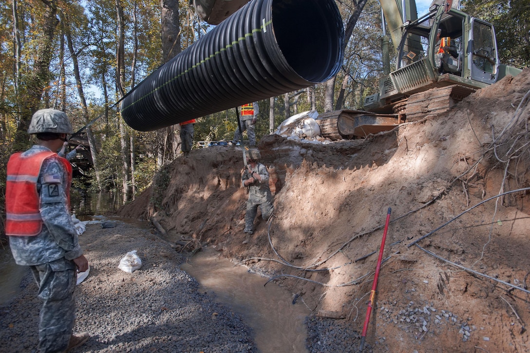 South Carolina Army National Guardsmen work to replace a washed out culvert on a Lexington County road in Gilbert, S.C., Oct. 24, 2015. South Carolina Army National Guard photo by Sgt. Brian Calhoun 