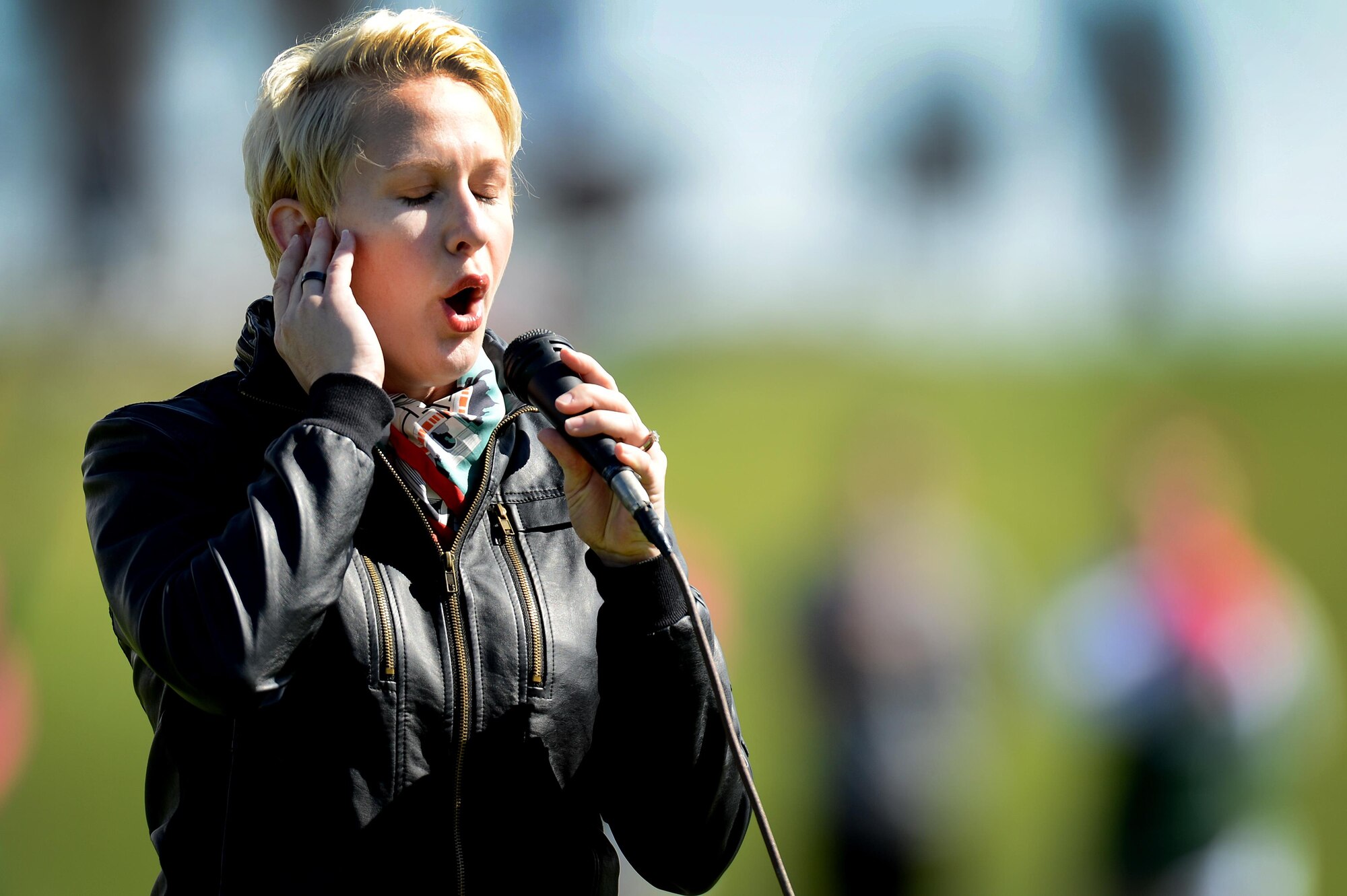 U.S. Air Force Tech. Sgt. Amber Fitzpatrick, 43rd Intelligence Squadron, sings the national anthem prior to kick-off at a military appreciation game at Blackwater Draw Stadium Oct. 24, 2015, in Clovis, N.M. Service members were invited to attend the free football game as the Greyhounds took on Angelo State. (U.S. Air Force photo/Staff Sgt. Matthew Plew)