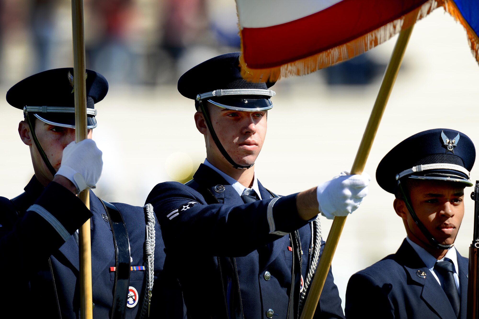 U.S. Air Force Airman 1st Class Nicholas Johnson, 27th Special Operations Wing honor guardsman, dips the Air Force flag during the presentation of the colors at a military appreciation game at Blackwater Draw Stadium Oct. 24, 2015, in Clovis, N.M. Service members were invited to attend the free football game as the Greyhounds took on the Angelo State University. (U.S. Air Force photo/Staff Sgt. Matthew Plew)