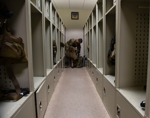 Lt. Col. Martin Schweim, 18th Flight Test Squadron CV-22B Osprey pilot, gathers aircrew flight equipment before a night-flying training mission, at Hurlburt Field, Fla., Oct. 22, 2015.  The CV-22B Osprey pilots fly night sorties to practice using night-vision equipment and perform tactics critical to successful real-world operations. (U.S. Air Force photo by Senior Airman Ryan Conroy/Released) 