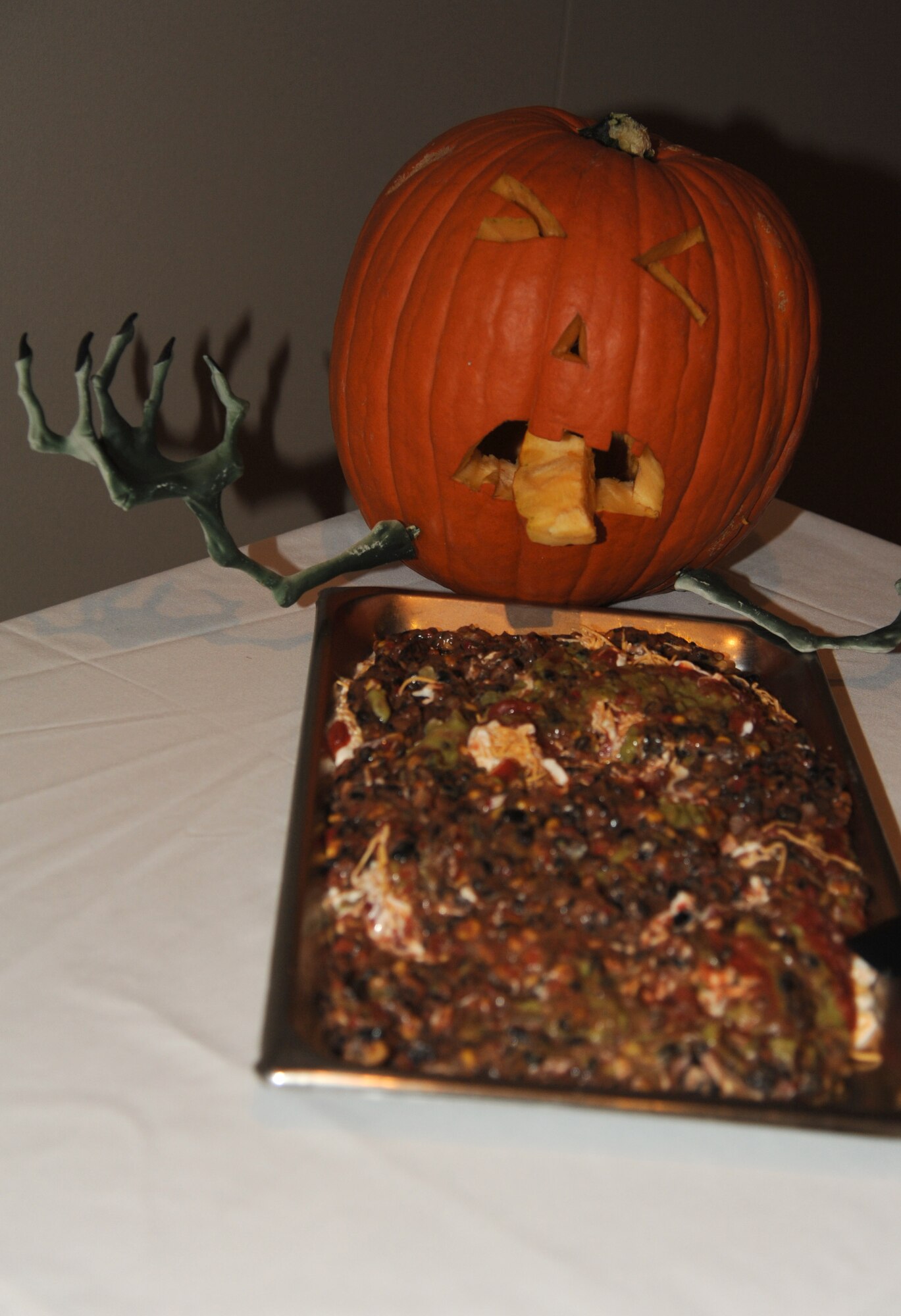 A pumpkin’s face is carved to portray chip dip as pumpkin puke during the Gross and Grody Buffet at the Event Center on Goodfellow Air Force Base, Texas, Oct. 24, 2015. The Gross and Grody Buffet was served during the Zombie Prom, one of the many events of Ghoulfellow celebration.  (U.S. Air Force photo by Airman Caelynn Ferguson/Released)