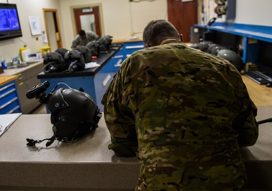Lt. Col. Martin Schweim, 18th Flight Test Squadron pilot, signs out a helmet at aircrew flight equipment before a night-flying training mission, at Hurlburt Field, Fla., Oct. 22, 2015. The CV-22B Osprey pilots fly night sorties to practice using night-vision equipment and perform tactics critical to successful real-world operations. (U.S. Air Force photo by Senior Airman Ryan Conroy/Released)