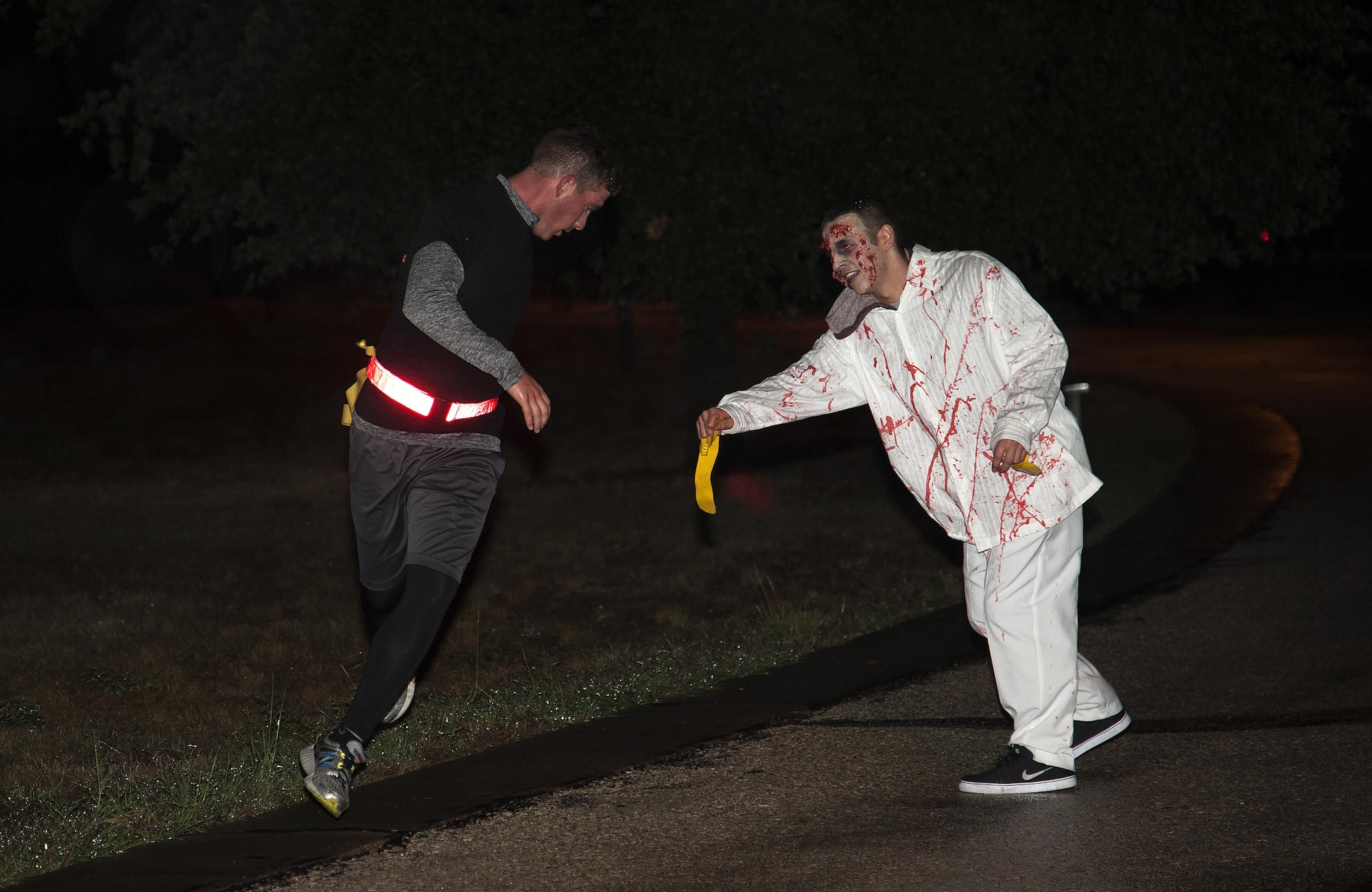 U.S. Air Force Airman Antonyo Villarreal, 312th Training Squadron student, shuffles towards a runner during the Zombie Run of Ghoulfellow at Louis F. Garland Department of Defense Fire Academy on Goodfellow Air Force Base, Texas, Oct. 24, 2015. Volunteers from various squadrons on base dressed up as zombies to take the runners’ flags and tag them out during the Zombie Run. (U.S. Air Force photo by Airman Caelynn Ferguson/Released)