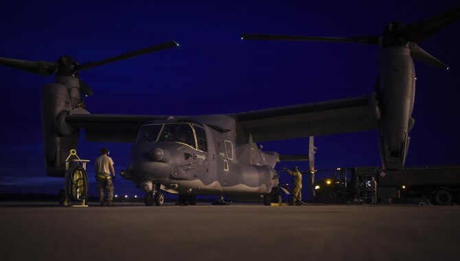 Airmen with the 1st Special Operations Logistics Readiness Squadron petroleum, oil and lubricants shop, fuel a CV-22B Osprey before a night-flying training mission on Hurlburt Field, Fla., Oct. 22, 2015. The Osprey is a tilt-rotor aircraft that combines the vertical takeoff, hover and vertical landing qualities of a helicopter with the long-range, fuel efficiency and speed characteristics of a turboprop aircraft. (U.S. Air Force photo by Senior Airman Ryan Conroy/Released)