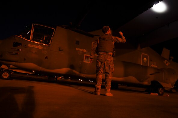 Capt. Bryan Jones, 8th Special Operations Squadron CV-22B Osprey pilot, performs a pre-flight inspection before a night-flying training mission, on Hurlburt Field, Fla., Oct. 22, 2015. Osprey pilots perform simulated combat missions at night to train on using night-vision equipment and perform tactics critical to successful real-world operations. (U.S. Air Force photo by Senior Airman Ryan Conroy/Released)