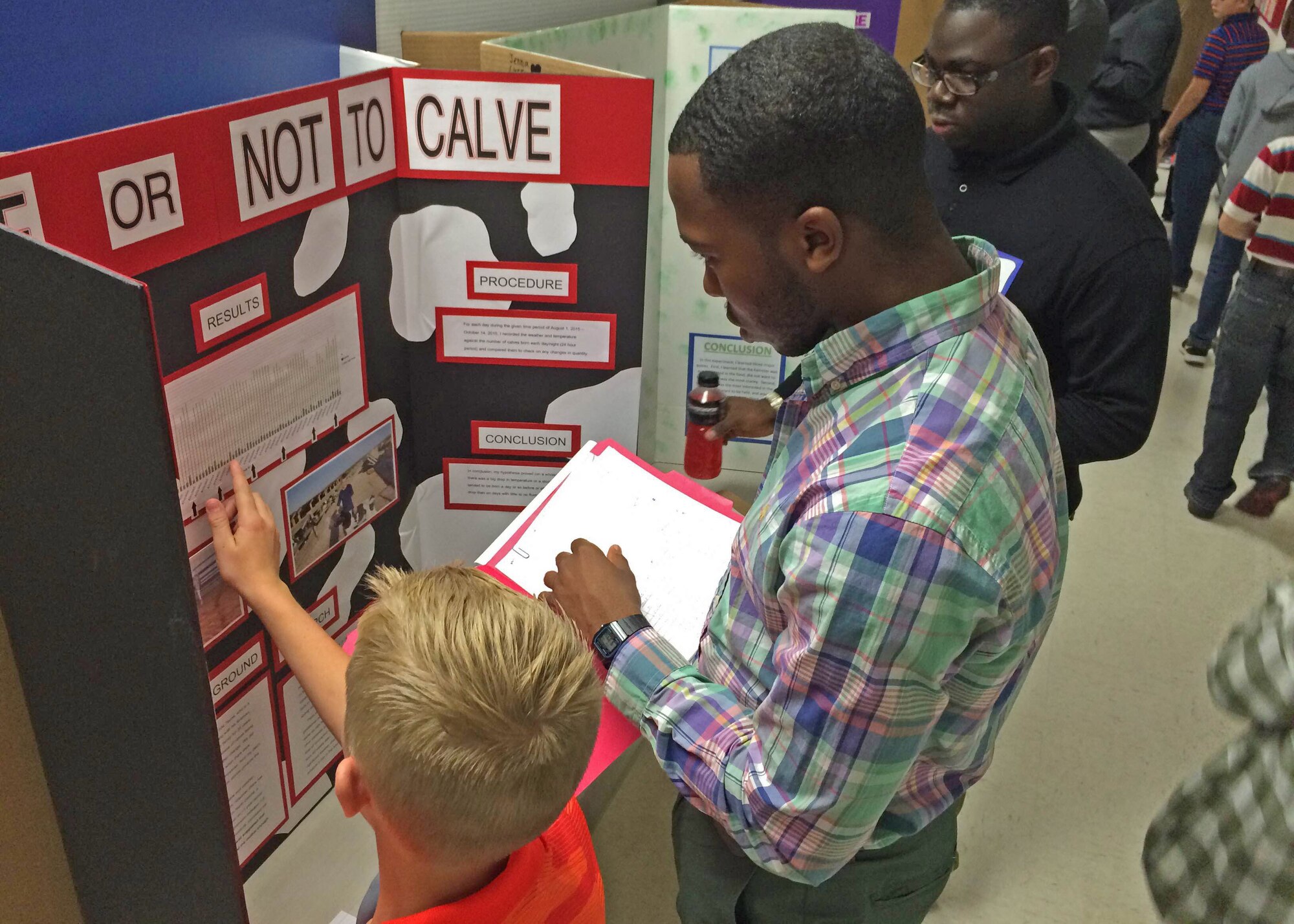An Air Commando with the 27th Special Operations Wing judges a student’s project during the local 2015 International Science and Engineering Fair, Oct. 23, 2015, in Clovis, N.M. Airmen had an opportunity to critique projects in a variety of categories, including microbiology, biomedical and health sciences, animal sciences, and cellular and molecular biology; all while meeting with students who presented their research in the name of science. (U.S. Air Force photo/Staff Sgt. Alexx Pons) 