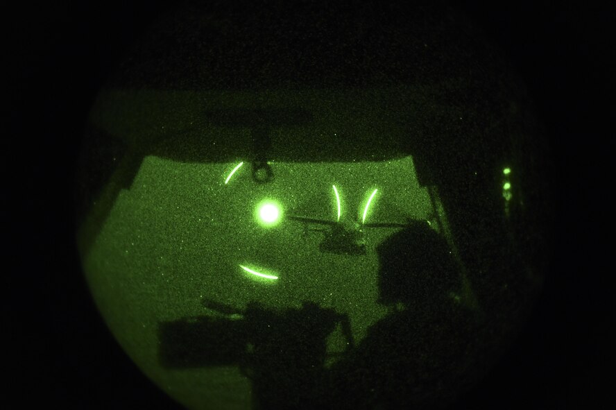 A CV-22B Osprey flies in formation as Chief Master Sgt. Barry Fegan, 8th Special Operations Squadron flight engineer instructor, provides security during a full-mission profile over Hurlburt Field, Fla., Oct. 22, 2015. The CV-22B Osprey is a tilt-rotor aircraft that combines the vertical takeoff, hover and vertical landing qualities of the helicopter with a long-range, fuel efficiency and speed characteristics of a turboprop aircraft. (U.S. Air Force photo by Senior Airman Ryan Conroy/Released)