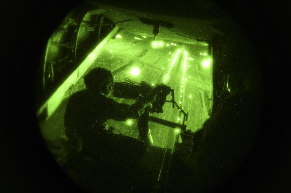Chief Master Sgt. Barry Fegan, 8th Special Operations Squadron flight engineer instructor, provides simulated security with a .50 caliber machine gun during a CV-22B Osprey takeoff, over Hurlburt Field, Fla., Oct. 22, 2015. The primary mission of the Osprey is to supply special operations forces with long-range infiltration, exfiltration and resupply. (U.S. Air Force photo by Senior Airman Ryan Conroy/Released) 