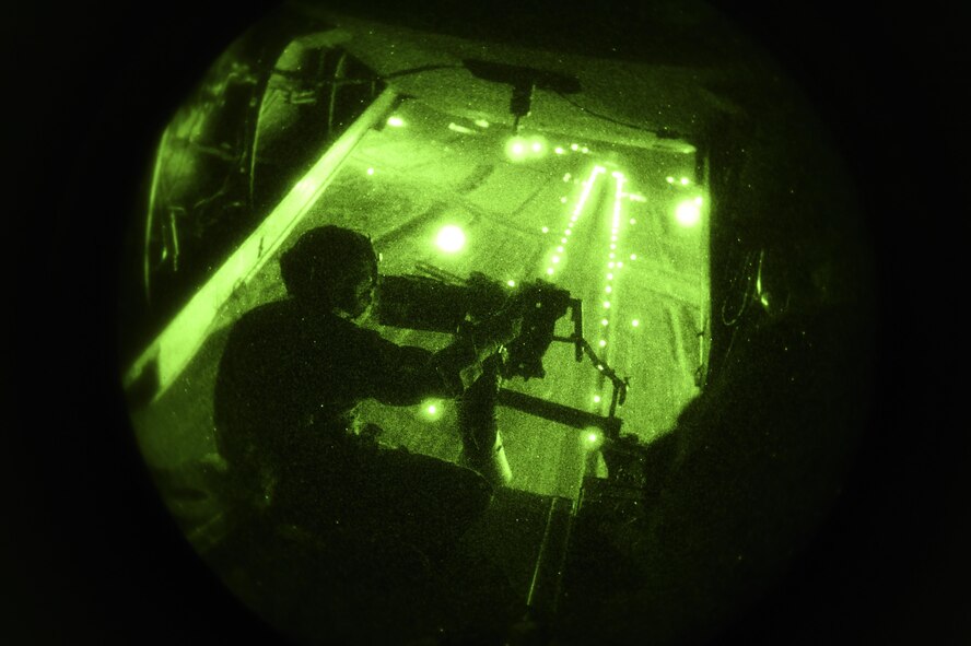 Chief Master Sgt. Barry Fegan, 8th Special Operations Squadron flight engineer instructor, provides simulated security with a .50 caliber machine gun during a CV-22B Osprey takeoff, over Hurlburt Field, Fla., Oct. 22, 2015. The primary mission of the Osprey is to supply special operations forces with long-range infiltration, exfiltration and resupply. (U.S. Air Force photo by Senior Airman Ryan Conroy/Released) 