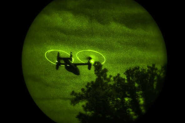 A CV-22B Osprey flies over a tree line during a night-flying sortie over Hurlburt Field, Fla., Oct. 22, 2015. The Osprey is a tilt-rotor aircraft that combines the vertical takeoff, hover and vertical landing qualities of a helicopter with the long-range, fuel efficiency and speed characteristics of a turboprop aircraft. (U.S. Air Force photo by Senior Airman Ryan Conroy/Released)