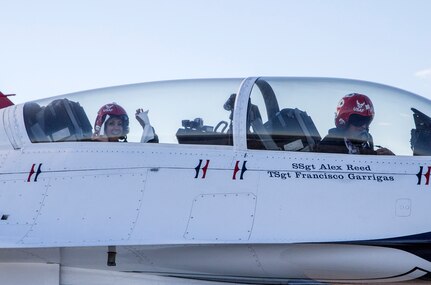 Maj. Tyler Ellison, U.S. Air Force Air Demonstration Squadron "Thunderbirds" operations officer, prepares to depart with passenger Delaine Mathieu, News 4 San Antonio co-anchor, for a media flight Oct. 26, 2015 at Joint Base San Antonio-Randolph, Texas. The Thunderbirds are performing in the 2015 Air Show and Open House to be held at JBSA-Randolph Oct. 31 and Nov. 1. (U.S. Air Force photo by Johnny Saldivar/Released)