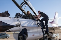 Tech Sgt. Jacob Worthen, U.S. Air Force Air Demonstration Squadron "Thunderbirds" avionics technician, assist Delaine Mathieu, News 4 San Antonio co-anchor, exit an F-16 aircraft Oct. 26, 2015 at Joint Base San Antonio-Randolph, Texas. The Thunderbirds are performing in the 2015 Air Show and Open House to be held at JBSA-Randolph Oct. 31 and Nov. 1. (U.S. Air Force photo by Johnny Saldivar/Released)