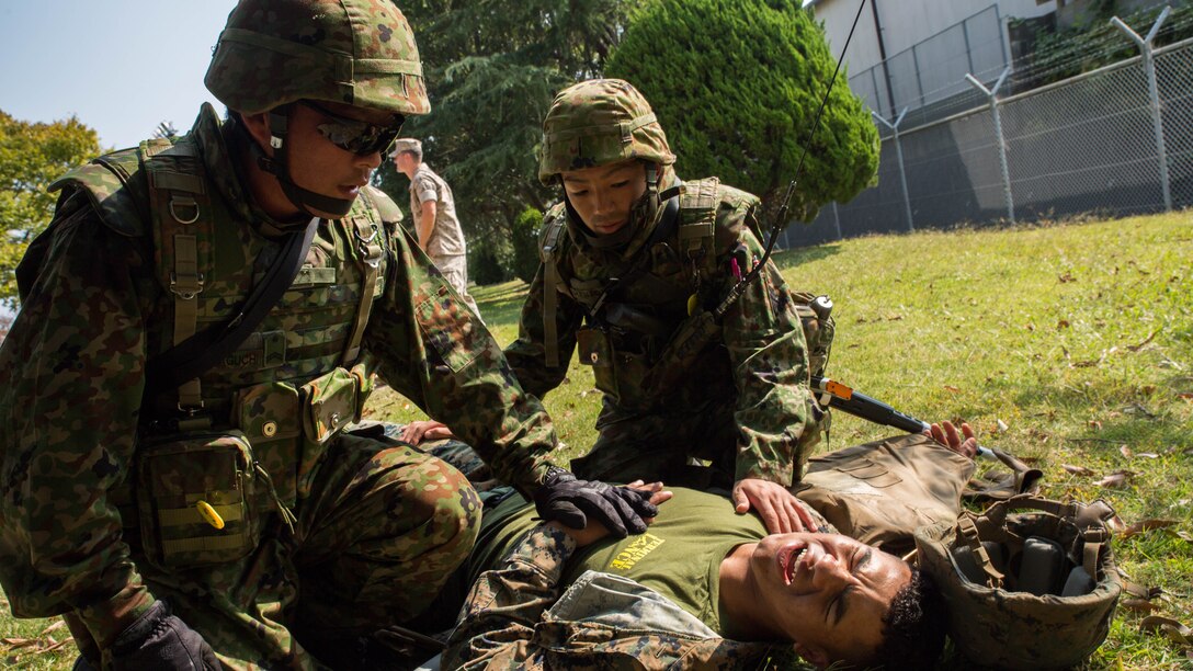 Japan Ground Self-Defense Force soldiers treat an injured Marine during a simulated improvised explosive device explosion during Exercise Guard and Protect at Marine Corps Air Station Iwakuni, Japan, Oct. 20-23, 2015. Exercise Guard and Protect is a joint security force operation that enables the station’s readiness in case the station has to make a defense posture. During the exercise Marines and JGSDF soldiers had to overcome the language barriers in order to effectively accomplish the mission. 