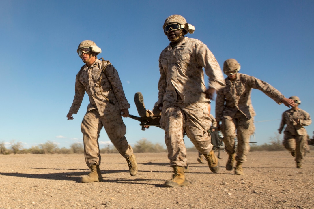 Sailors carry a simulated patient on a stretcher during a casualty evacuation exercise at Fire Base Burt, Chocolate Mountain Aerial Gunnery Range, Calif., Oct. 22, 2015. The sailors are corpsmen assigned to 1st Medical Battalion, 1st Marine Logistics Group. U.S. Marine Corps photo by Lance Cpl. Roderick L. Jacquote 