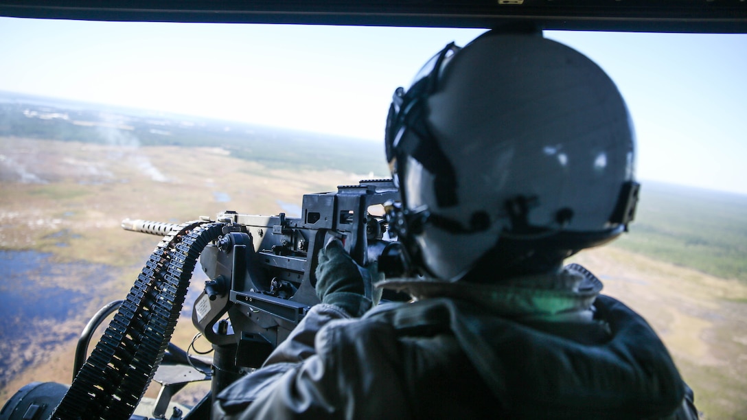 Staff Sgt. James Hohenstein, a crew chief with Marine Light Attack Helicopter Squadron 167, mans a GAU-21 .50 caliber mounted machine gun during urban close air support training at Marine Corps Base Camp Lejeune, N.C., Oct. 19, 2015. Marines with HMLA-167 flew in a UH-1Y Venom to Camp Lejeune to assist joint terminal air controllers conducting realistic training with air support. 