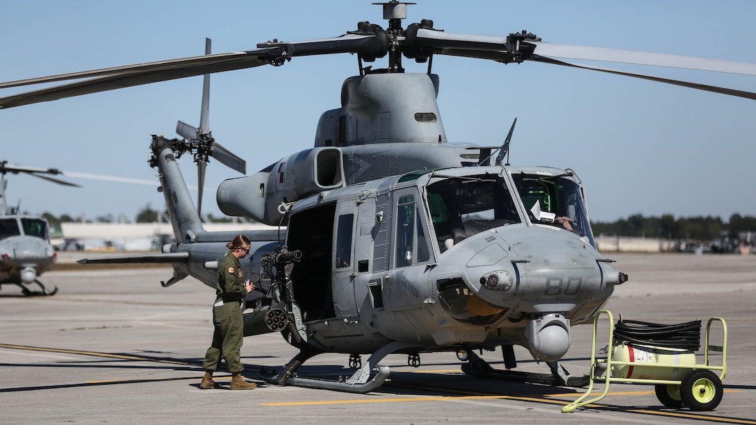 Cpl Candice A. Cross, an aviation ordnance technician with Marine Light Attack Helicopter Squadron 167 visually inspects a UH-1Y Venom before it conducts urban close air support training at Marine Corps Base Camp Lejeune, N.C., Oct. 19, 2015. Marines with HMLA-167 flew to Camp Lejeune to assist joint terminal air controllers conducting realistic training with air support. 
