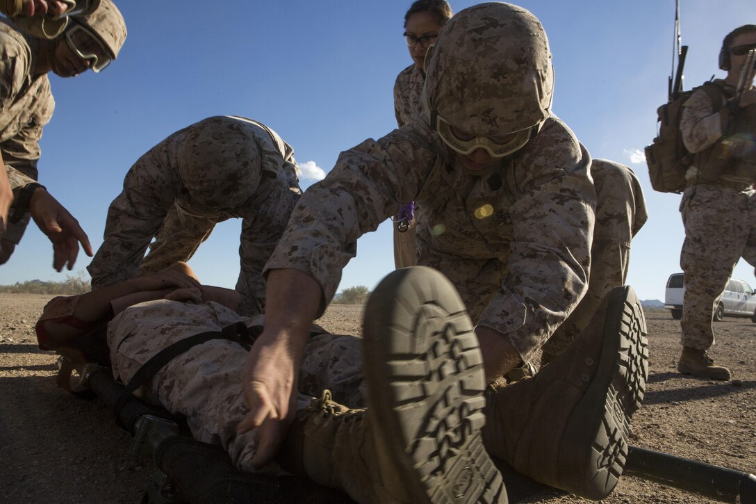 Navy Petty Officer 3rd Class Daniel Evans, foreground, treats a simulated patient during a casualty evacuation exercise at Fire Base Burt, Chocolate Mountain Aerial Gunnery Range, Calif., Oct. 22, 2015. Evans is a hospital corpsman assigned to 1st Medical Battalion, 1st Marine Logistics Group. U.S. Marine Corps photo by Lance Cpl. Roderick L. Jacquote