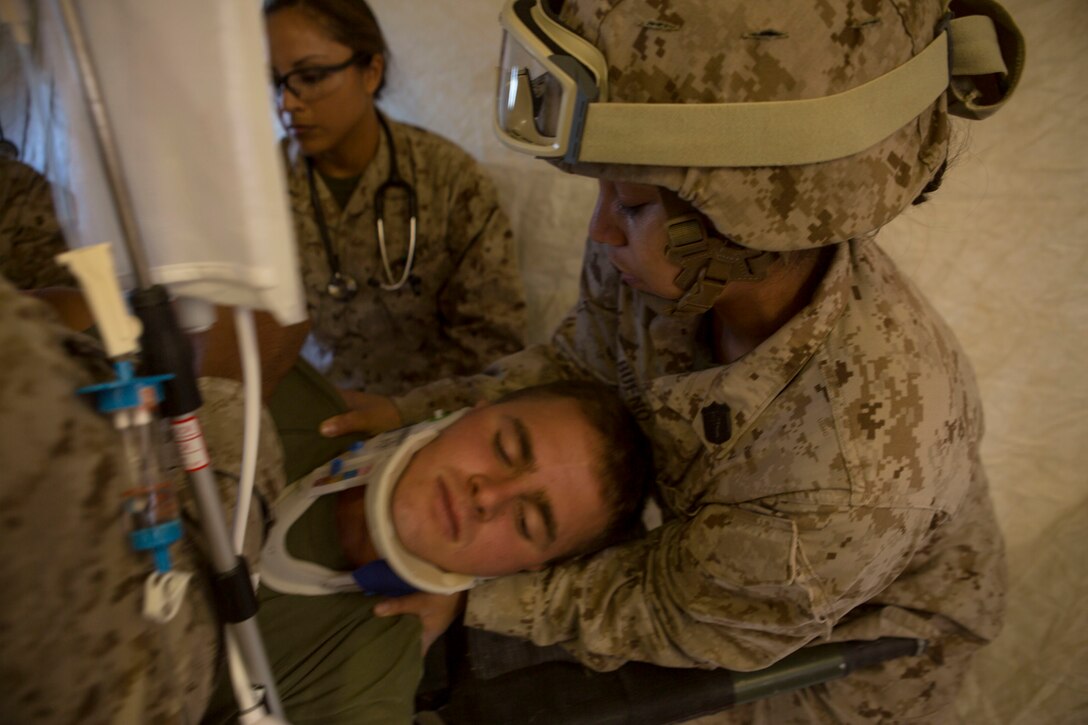 Navy Petty Officer 1st Class Bonnie Bueno, right treats a simulated patient during a casualty evacuation exercise at Fire Base Burt, Chocolate Mountain Aerial Gunnery Range, Calif., Oct. 22, 2015. Bueno is a hospital corpsman assigned to 1st Medical Battalion, 1st Marine Logistics Group. U.S. Marine Corps photo by Lance Cpl. Roderick L. Jacquote