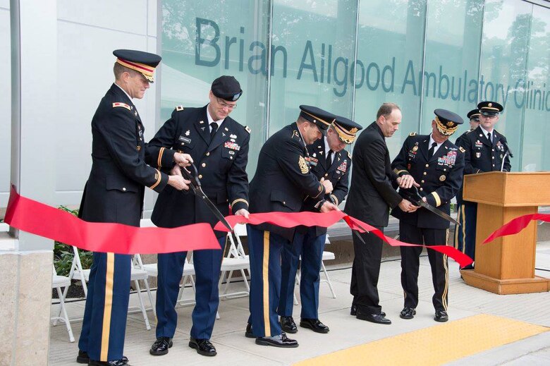 Left, Col. David A. Caldwell, Commander, New York District of the Army Corps. of Engineers; Col. Michael Brennan, Commander, U.S. Army Health facility Planning Agency; Command Sgt. Maj. Vincent E. Bond, Command Sergeant Major, West Point Health Service Area; Col. Brian S. Burlingame, Commander, West Point Health Service Area; Mr. Bradley Allgood; and Lt. Gen. Robert L. Caslen, Jr., Superintendent, U.S. Military Academy, cut the ribbon in a gesture to ceremonially open the Brian D. Allgood Ambulatory Clinic addition to Keller Army Community Hospital at West Point, New York, Oct. 7. The approximate 50,000 square foot addition provides modernized primary care space and is the precursor to a multi-phase renovation of the existing hospital.
