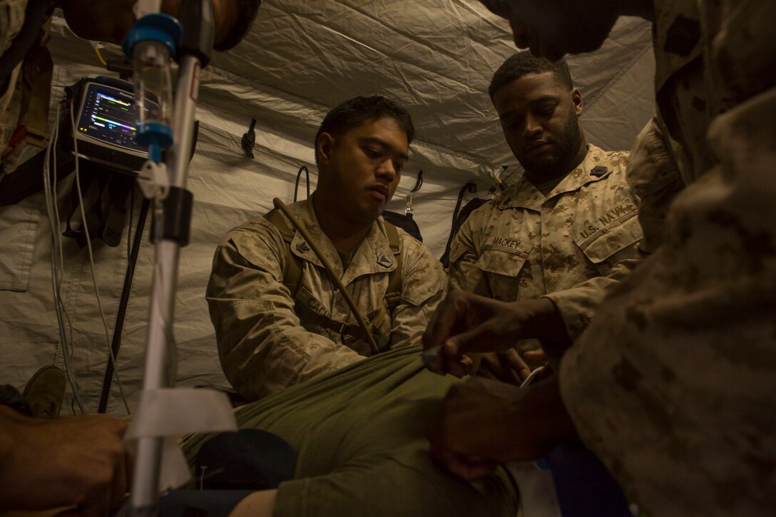 Sailors treat a simulated patient during a casualty evacuation exercise at Fire Base Burt, Chocolate Mountain Aerial Gunnery Range, Calif., Oct. 22, 2015. U.S. Marine Corps photo by Lance Cpl. Roderick L. Jacquote